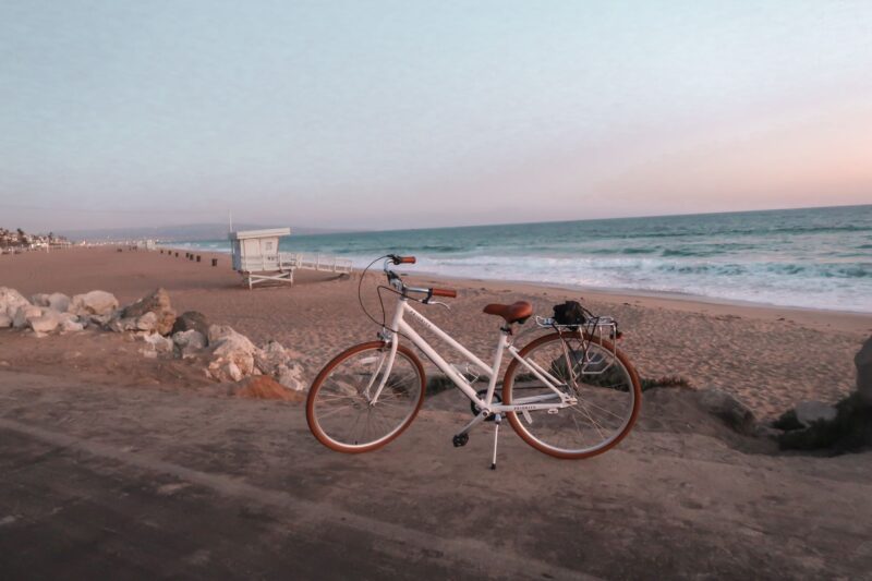 Priority Classic Plus Bike review: a lightweight, affordable beach cruiser bike with white frame and brown wheels, coming in multiple colors